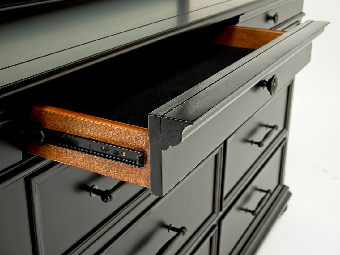 Close up of a open drawer on a black dresser